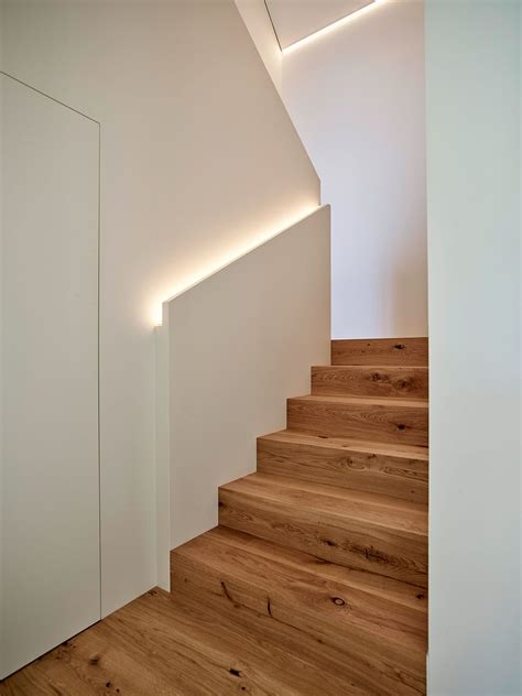 The Stairs Are Made Of Wood And Have Lights On Each Side Along With