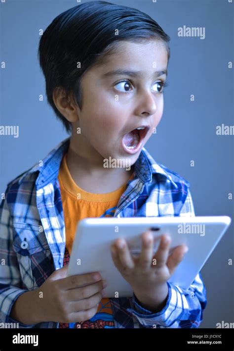 Child Looking At The Camera With An Amazed Look Stock Photo Alamy