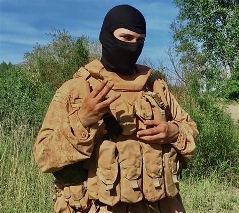 A Man Wearing A Black Mask And Holding Something In His Hands While