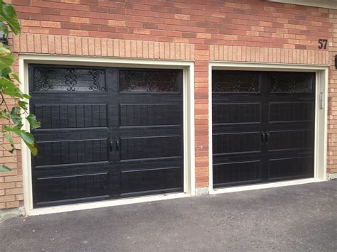 8x7 Clopay steel insulated long panel Carriage Doors in Black with Wrought Iron Windows | Metal ...