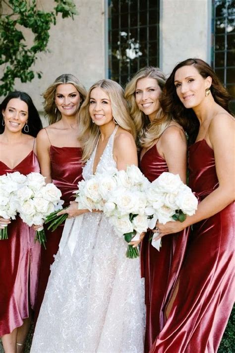 The Bridesmaids Are All Wearing Red Dresses And Holding Bouquets In