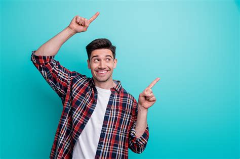 Photo Of Cheerful Positive Man Dressed Plaid Shirt Looking Pointing Two Fingers Empty Space