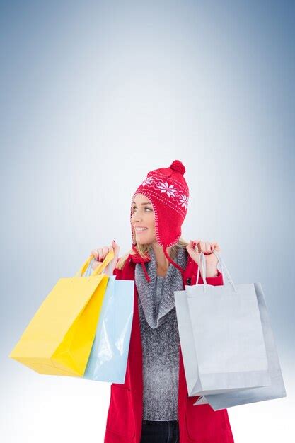 Premium Photo Blonde In Winter Clothes Holding Shopping Bags