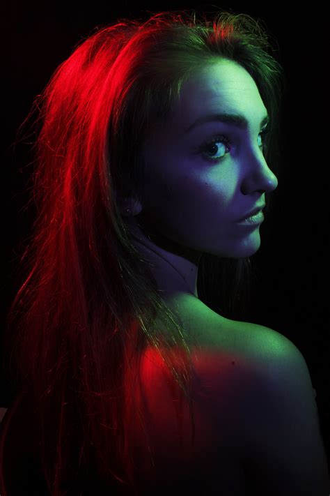 A Woman With Long Red Hair And Blue Eyes Is Looking At The Camera While