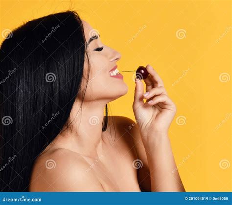 Portrait Of Happy Smiling Naked Brunette Woman With Closed Eyes Eating Biting Fresh Cherry Berry
