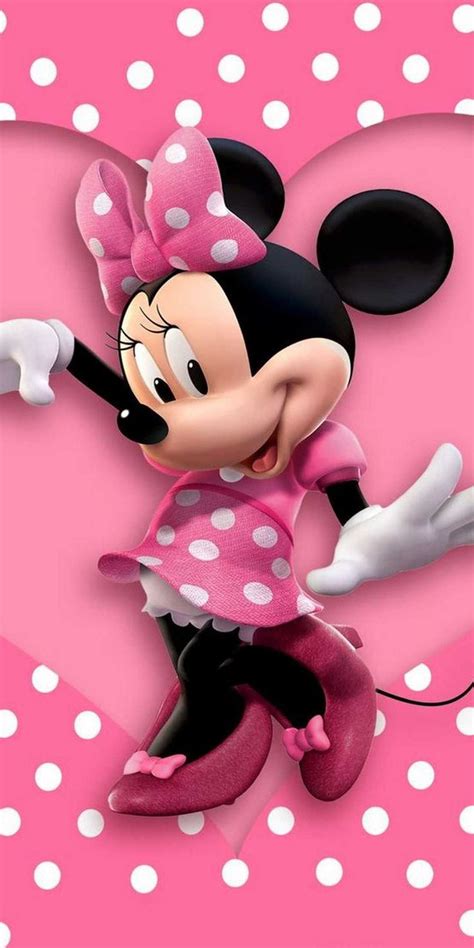 A Minnie Mouse With Polka Dots On Its Head And Arms Standing In Front