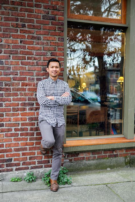 Small Business Owner Standing In Front Of His Store By Stocksy