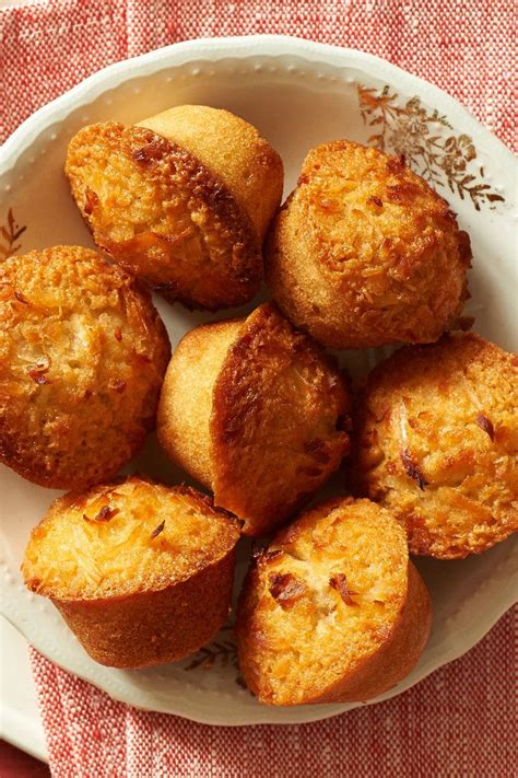 A White Plate Topped With Muffins On Top Of A Red And White Table Cloth