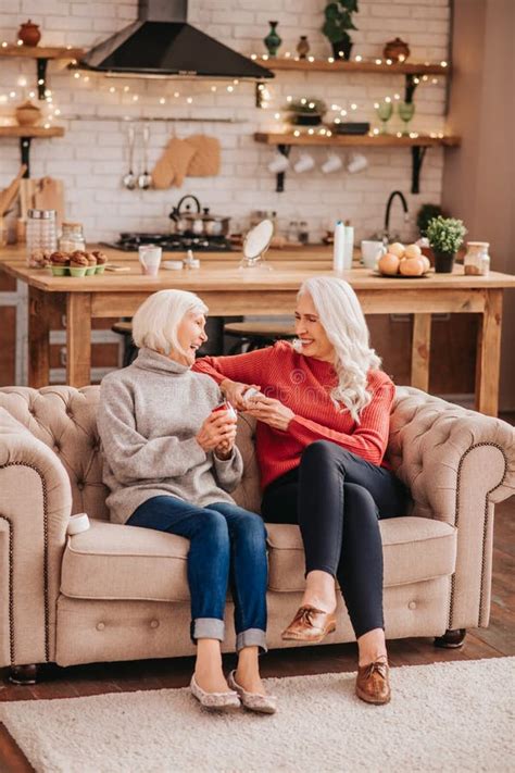 Two Mature Grey Haired Positive Ladies Feeling Amused Stock Photo