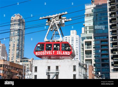 People riding Roosevelt Island red gondola of aerial tramway - New York ...