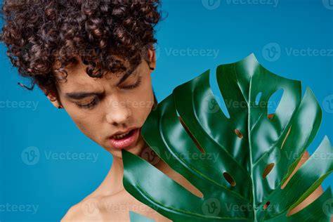 Handsome Man With Curly Hair Naked Shoulders Green Leaf Clear Skin