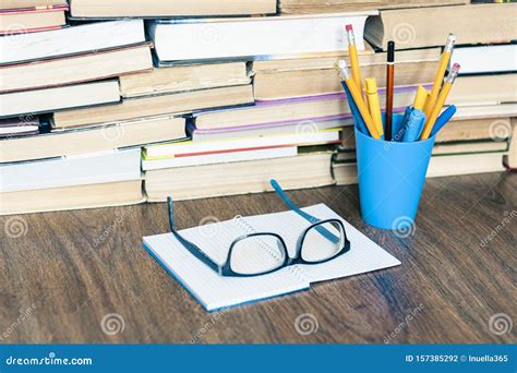 Stack Of Old Book Pens And Pencils In Holder Open Notebook And