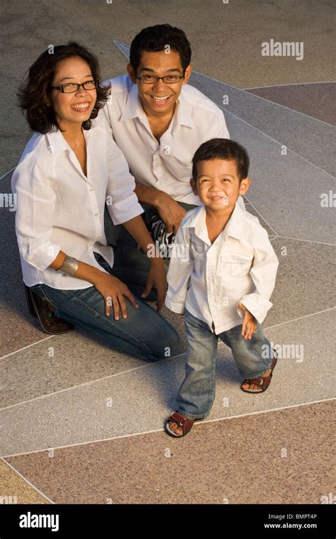 Happy Thai family enjoying late afternoon sun Stock Photo - Alamy