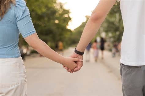 Free Photo | Girl and boy holding hands close-up