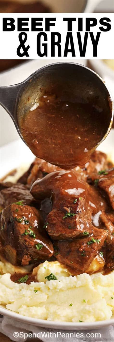 Beef Tips And Gravy Is Being Served Over Mashed Potatoes On A White Plate