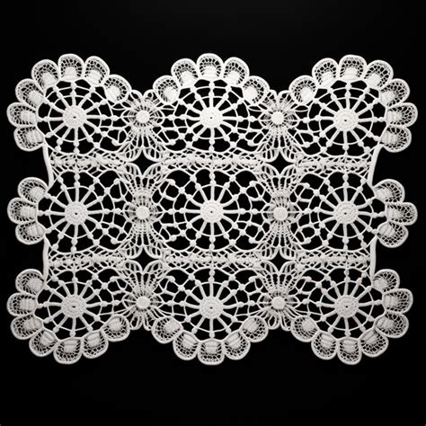 Premium AI Image A Close Up Of A White Doily On A Black Background