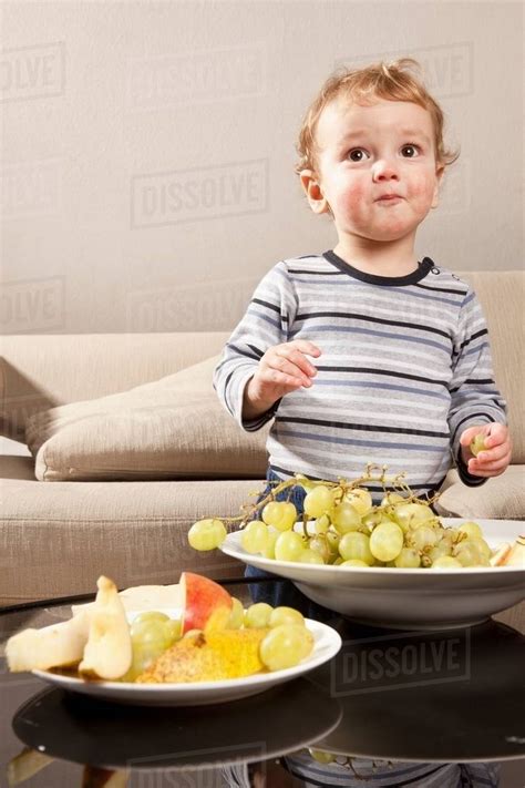 Little Boy Eating Grapes Stock Photo Dissolve