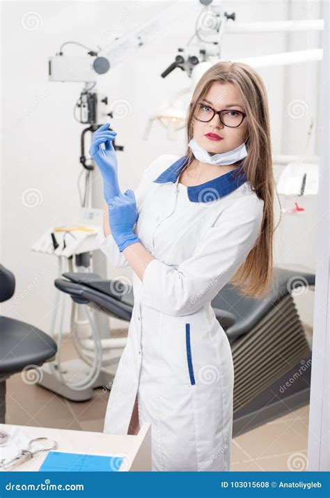 Portrait Of Young Attractive Female Dentist Holding Dental Tool At The