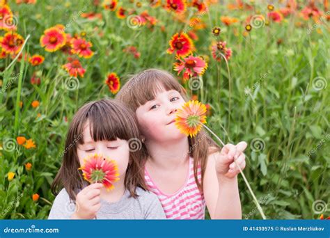 Two Small Children With Flowers Stock Photo - Image: 41430575