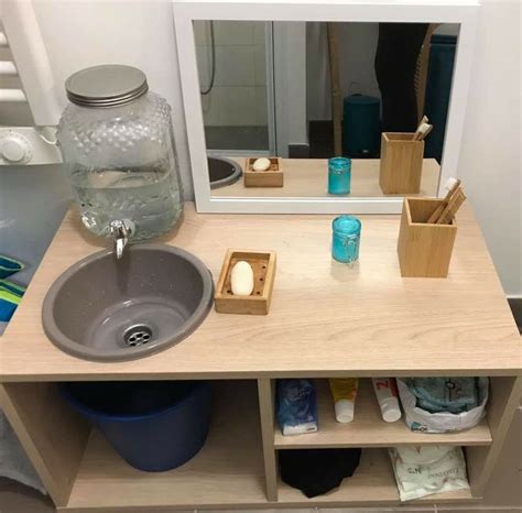 A Bathroom With A Sink Mirror And Shelves On The Wall Next To Toiletries