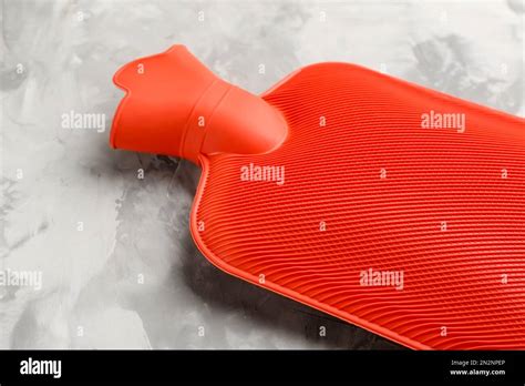 Red Rubber Hot Water Bottle On Light Grey Stone Background Closeup Stock Photo Alamy