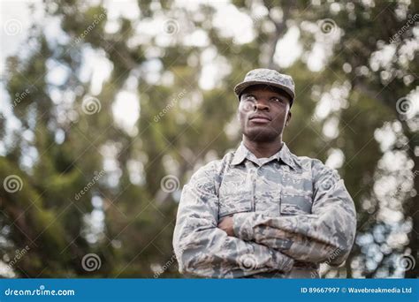 Thoughtful Military Soldier Standing With Arms Crossed Stock Image