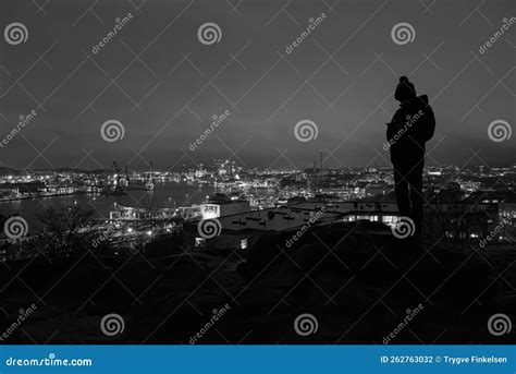 A Kid Looking Out Over A City At Night Editorial Photography Image