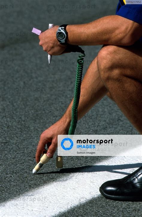 A Michelin Tyre Technician Checks The Track Temperature Using A 2 Part