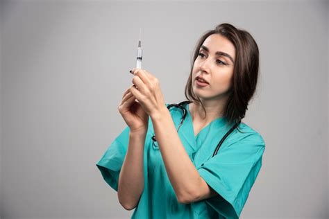 Free Photo Female Doctor In Uniform Preparing Syringe