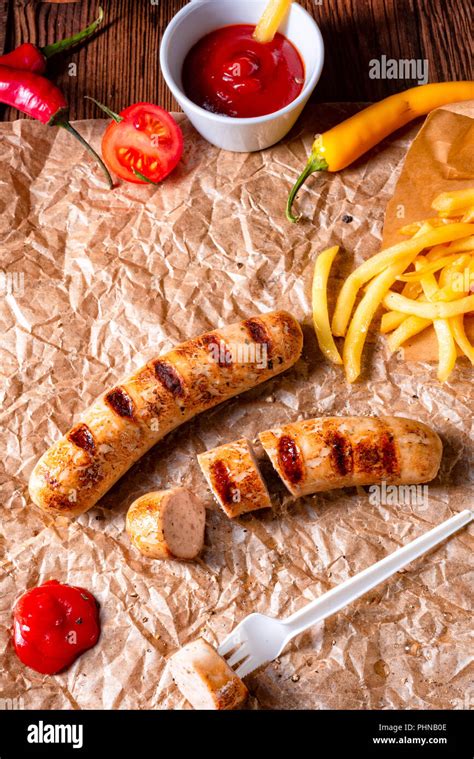 Rustic Bratwurst With Pommes And Hot Ketchup Stock Photo Alamy