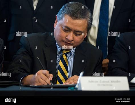 Adnan Zainal Abidin Of Petronas Participates In A Signing Ceremony