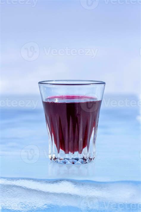 Red Tincture In A Small Glass Is On The Ice Alcohol In A Glass On