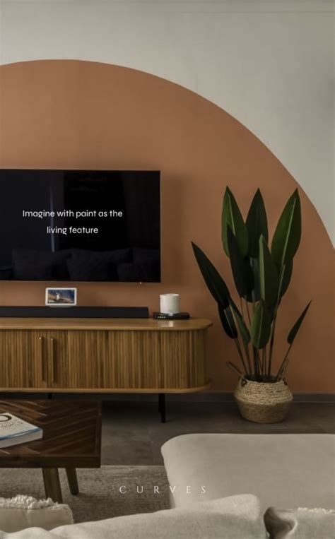 A Flat Screen Tv Sitting On Top Of A Wooden Entertainment Center Next