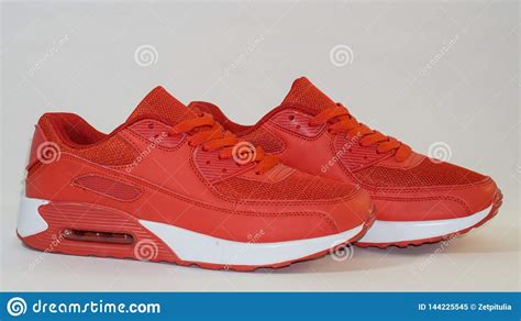 Close Up Red Sports Sneakers With White Sole On A White Background