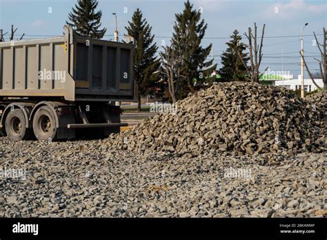 A Dump Truck Is Dumping Gravel On A Construction Site Dump Truck Dumps