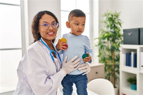 Mother And Son Pediatrician And Patient Hugging Each Other At Clinic Stock Image Image Of