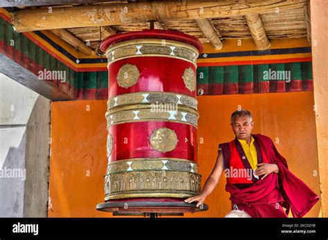 Buddhist Monk Turns A Large Prayer Wheel At The Lamayuru Monastery