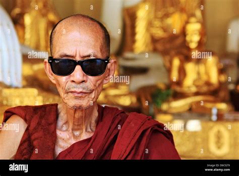 A Monk With Sunglasses Is Sitting At Shwedagon Pagoda In Yangon