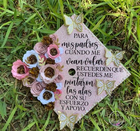 A Pink Graduation Cap With Flowers On The Grass