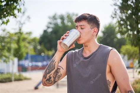 Premium Photo | Young athlete drinking water from the bottle