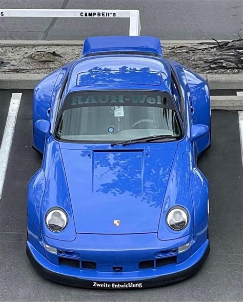 Blue Porsche Sports Car In Parking Lot