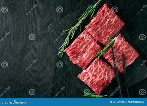 Sliced Wagyu Marbled Beef For Yakiniku On Plate On Black Background