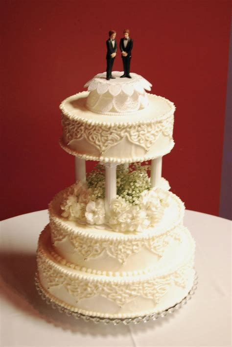 Everything Is Frosted Traditional Wedding Cake With Pillars And Fresh