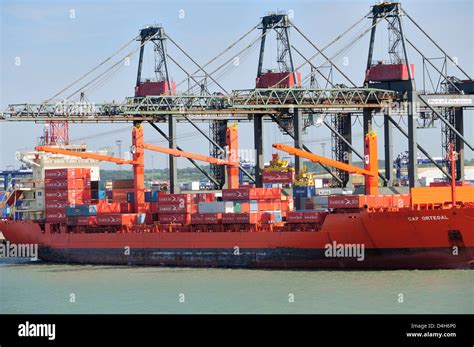 Container Being Loaded Onto Container Ship By Loading Derrick At