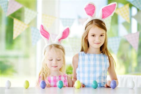 Two Cute Little Sisters Wearing Bunny Ears Playing Egg Hunt On Easter Stock Image Image Of