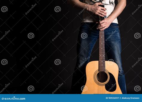 Guitarist Holding Two Hands With An Acoustic Guitar On A Black Isolated