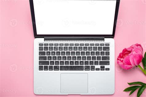 Beautiful pink peony flower and laptop with copy space for your text on ...