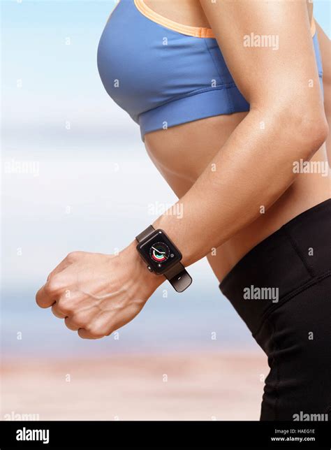 Woman Jogging Outdoors Wearing Apple Watch Smartwatch On Her Wrist Displaying Activity And