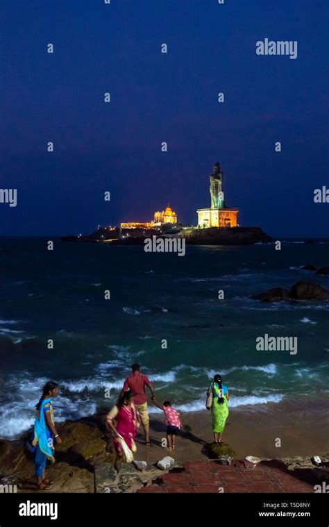 Vertical view of the Vivekananda rock memorial and Thiruvalluvar Statue lit up at night in ...