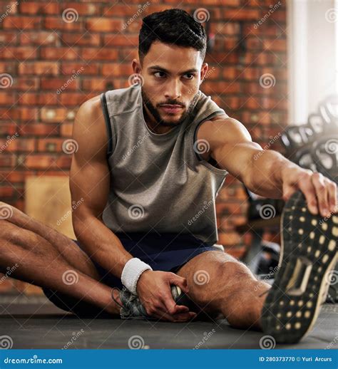 Fitness Man And Stretching Legs For Warm Up At Gym With Motivation